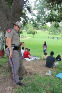 J4 Troopers Listen to Buehler - TexasOccupyMovement.org A state trooper leans against a tree as he listens to a class.