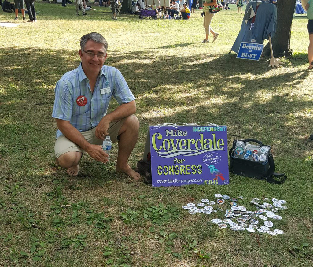Mike Coverdale, an independent candidate for Congress poses with a small display promoting his candidacy outside the Wells Fargo Center in Philadelphia during the Democratic National Convention. July 27, 2016. (Kit O'Connell)