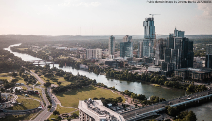 A photo of the Austin downtown city skyline. Added text: "Public domain image by Jeremy Banks via Unsplash"
